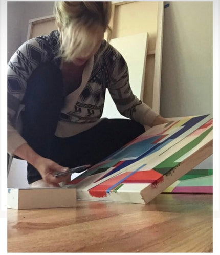 Shilo Ratner working in her studio on a geometric abstract painting
