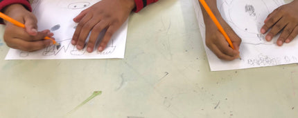 Students working on drawing in classroom with artist Shilo Ratner 