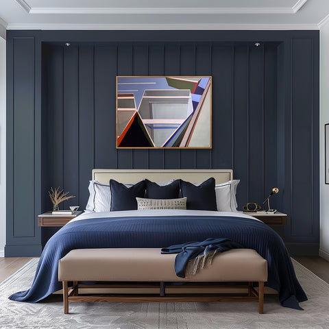 Artist Shilo Ratner, Abstract boat art painting, By the Dock, with geometric shapes in a modern bedroom with dark blue paneled walls, a bed with blue bedding, and abstract art above the bed.