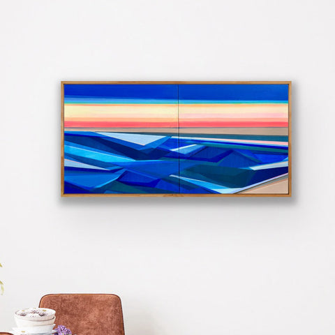 Artist Shilo Ratner painting Rise 20in x 40in, Modern water abstract painting of sunset with blue and red hues on a white wall