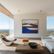 Artist Shilo Ratner, Standing Guard Painting, 48in x 60in Modern living room with abstract mountain art,, furniture, and large windows.