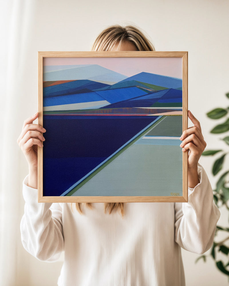 Original Abstract Mountain Painting Whisper of the Wild the painting features geometric shapes in shades of blue, navy, green, and pale pink, set in a light wood frame by Artist Shilo Ratner. 