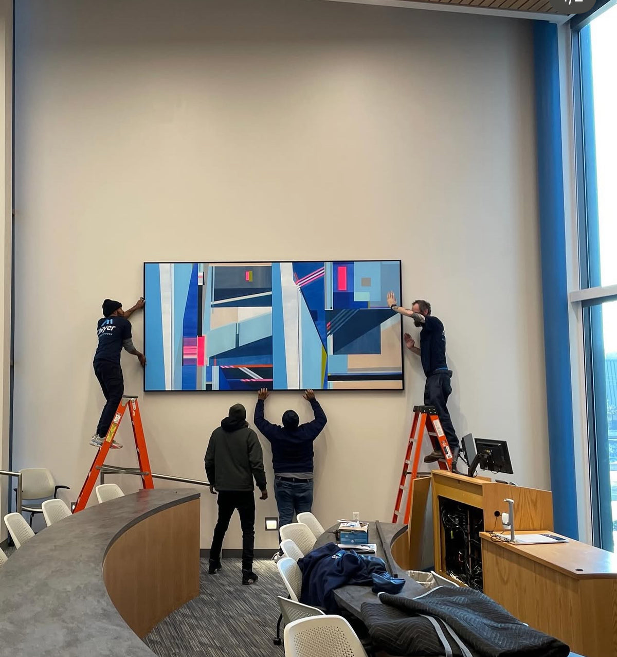 Installation of large geometric painting at Connecticut State University Business School by Shilo Ratner for public art project